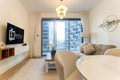 a living room with a couch and a table at Elite LUX Holiday Homes - Cozy City Escape in Standpoint Downtown in Dubai