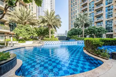a swimming pool with blue water in a building at Elite LUX Holiday Homes - Cozy City Escape in Standpoint Downtown in Dubai