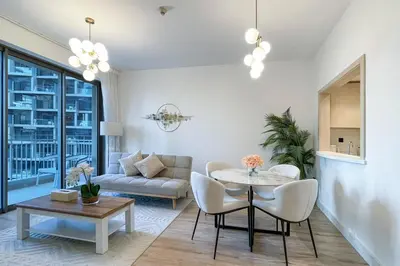 a living room with a table and a couch at Elite LUX Holiday Homes - Cozy City Escape in Standpoint Downtown in Dubai