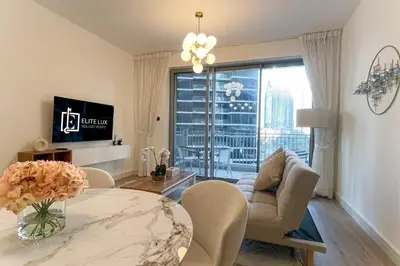 a living room with a table and a couch at Elite LUX Holiday Homes - Cozy City Escape in Standpoint Downtown in Dubai
