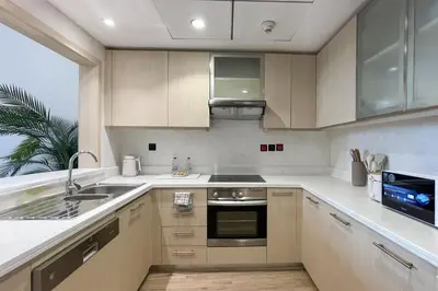 a kitchen with a sink and a stove top oven at Elite LUX Holiday Homes - Cozy City Escape in Standpoint Downtown in Dubai