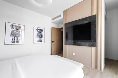 a bedroom with a bed and a flat screen tv at Creek Escape - Palace Residences - Creek Harbour in Dubai