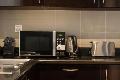 a microwave oven sitting on top of a kitchen counter at Palm Retreat - Anantara North - Palm Jumeirah in Dubai