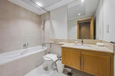 a bathroom with a toilet and a tub and a sink at SanctuaryStays - A Luxury apartment with Full Burj Khalifa and Dubai Fountain Views - Dubai Mall Access in Dubai