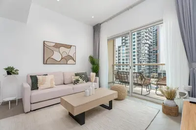 a living room with a couch and a large window at Gala Guests - Marina Views Bright Balcony Collection in Dubai