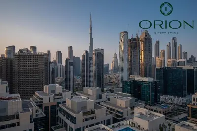 a view of a large city with a clock tower at Luxury 2BR with Private Jacuzzi Burj & Canal Views MINUTES FROM DUBAI MALL AND BURJ KHALIFA in Dubai