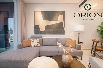 a living room with a couch and a table at Luxury 2BR with Private Jacuzzi Burj & Canal Views MINUTES FROM DUBAI MALL AND BURJ KHALIFA in Dubai