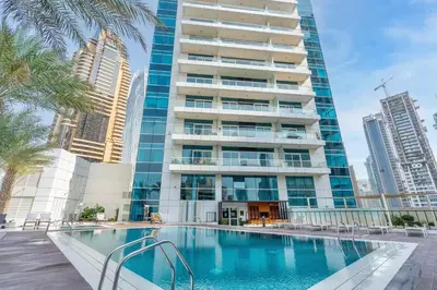 a swimming pool in front of a tall building at Elegant 1BR Apartment with Partial Sea View by EE holiday homes in Dubai