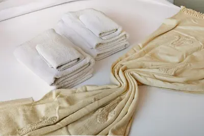 a pile of towels sitting on top of a table at Golden Stays - Elegant 4BR I Santorini-Style I Sunsets & Comfort in Dubai