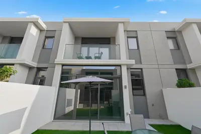 an umbrella in front of a building at Golden Stays - Stylish 4BR Villa I Garden, Pool & Parking I Global Village in Dubai