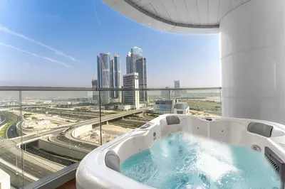 a bath tub in a building with a view of a city at Luxury 1BR Terraces Private Jacuzzi Business Bay in Dubai
