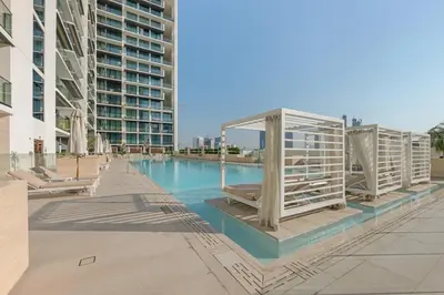 a swimming pool in the middle of a building at Waves - Comfy and Stylish 1BR with Huge Balcony in Dubai