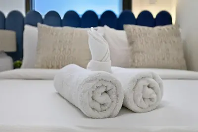 a towel animal made out of towels on a bed at Golden Stays - Chic 4BR Retreat I Luxe Touches & Serene Views in Dubai