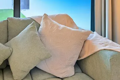 two pillows sitting on top of a couch at Golden Stays - Chic 4BR Retreat I Luxe Touches & Serene Views in Dubai