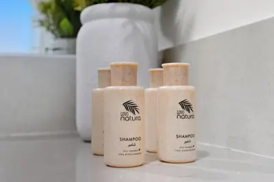 three bottles of shampoo are sitting on a counter at Golden Stays - Chic 4BR Retreat I Luxe Touches & Serene Views in Dubai
