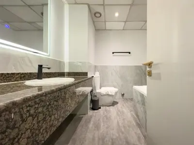 a bathroom with a sink and a toilet at Stylish 3BR JBR l Steps to Beach l Balcony l Sleeps 6 in Dubai