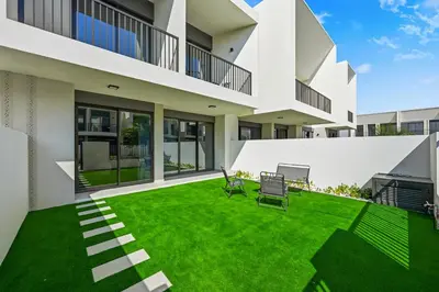 an image of a house with a green yard at Golden Stays - Modern Luxe 4BR Oasis I Peaceful Views in Dubai