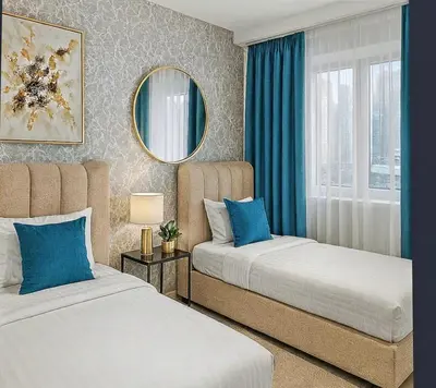 a bedroom with two beds and a mirror at Breathtaking 2BR in Marina - Steps to Metro in Dubai