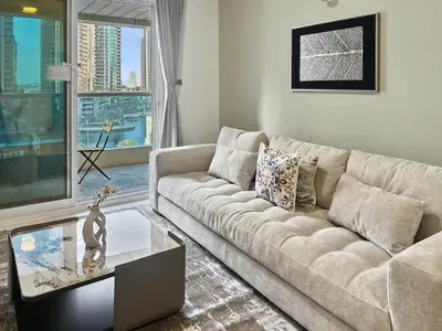 a living room with a couch and a glass table at Breathtaking 2BR in Marina - Steps to Metro in Dubai
