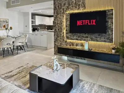a living room with a tv on a wall at Breathtaking 2BR in Marina - Steps to Metro in Dubai