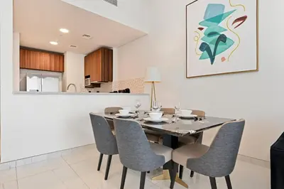 a dining room with a table and chairs at Golden Stays - Palm Views I Luxe 4BR Getaway I Tranquil Charm in Dubai