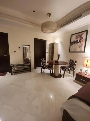 a large living room with a table and chairs at Ramadan Staycay King suite sunset stay sauna beachfront tennis pool and 24h security in Dubai