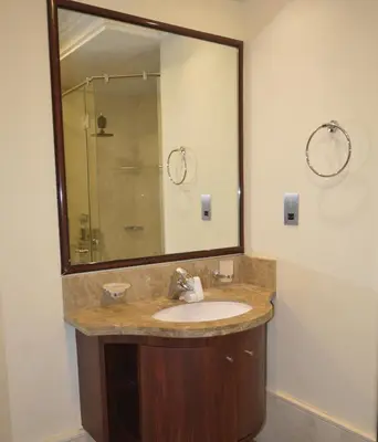 a bathroom with a sink and a large mirror at Ramadan Staycay King suite sunset stay sauna beachfront tennis pool and 24h security in Dubai