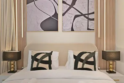 a bedroom with a bed with black and white pillows at Golden Stays - Italian Riviera 4BR Villa I Stylish Bliss Living in Dubai