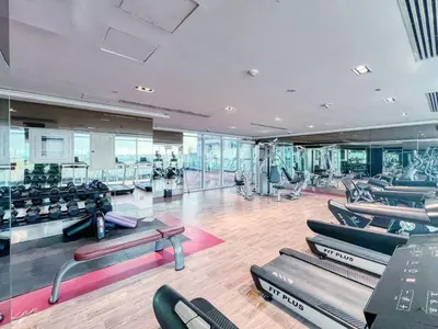 a gym with a bunch of chairs and tables at GuestReady - Studio l Close to Metro Station in Dubai