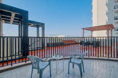 a balcony with two chairs and a table at GuestReady - Studio l Close to Metro Station in Dubai