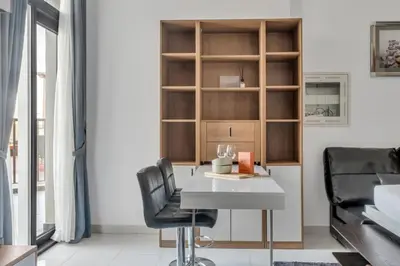 a dining room with a table and two chairs at GuestReady - Studio l Close to Metro Station in Dubai