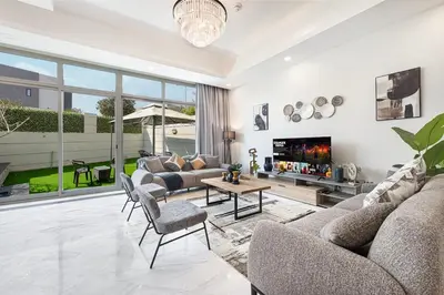 a living room with a couch and a table at Modern 4Bedroom Villa in Al Furjan in Dubai
