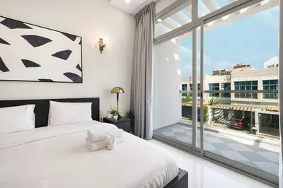 a bedroom with a bed and a large window at Modern 4Bedroom Villa in Al Furjan in Dubai