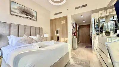 a bedroom with a large white bed in a room at Luxury Stay in Meydan - 10min to Downtown in Dubai