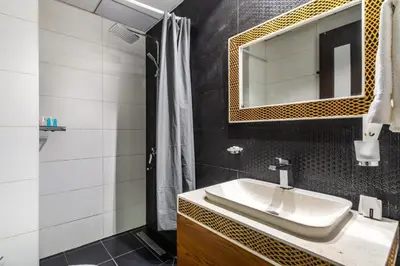 a bathroom with a sink and a mirror at GuestReady - Burj Khalifa View l Rooftop Pool in Dubai