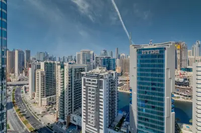 an aerial view of a city with tall buildings at GuestReady - Burj Khalifa View l Rooftop Pool in Dubai