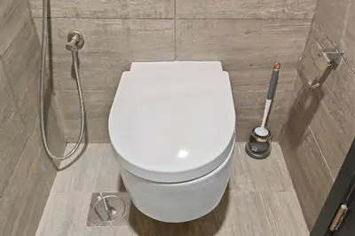 a white toilet in a bathroom with a shower at Golden Stays - Luxury 1BR Apartment I Cinema Access I Pool & Gym in Dubai