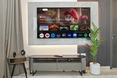 a room with a table and a display with an iphone at Golden Stays - Luxury 1BR Apartment I Cinema Access I Pool & Gym in Dubai
