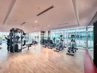 a gym with treadmills and cardio equipment in a building at GuestReady - 1BR l Close to Metro Station in Dubai