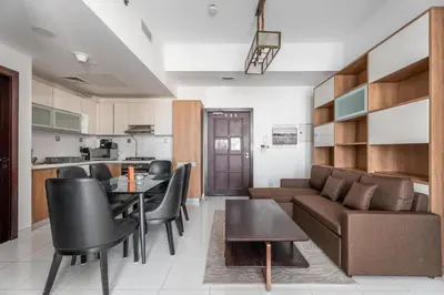 a living room with a couch and a table at GuestReady - 1BR l Close to Metro Station in Dubai