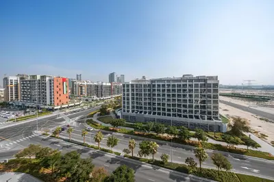 an aerial view of a city with a road and buildings at StayShort - Studio Apartment at Azizi Riviera with Balcony in Dubai