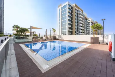 a swimming pool on the roof of a building at StayShort - Studio Apartment at Azizi Riviera with Balcony in Dubai