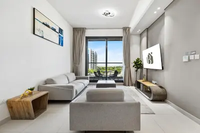 a living room with a couch and a table at BLVD - Stylish Stay with Relaxing Balcony View in Dubai