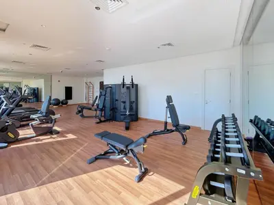 a gym with several treadmills and cardio machines at BLVD - Stylish Stay with Relaxing Balcony View in Dubai