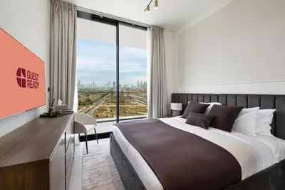 a bedroom with a large bed and a large window at GuestReady | 2 BR | Luxury Apt with Private Pool in Dubai