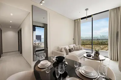 a living room with a couch and a table at GuestReady | 2 BR | Luxury Apt with Private Pool in Dubai