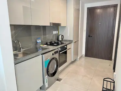 a kitchen with a sink and a washing machine at Modern studio in the centre of Dubai in Dubai