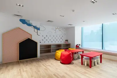 a classroom with two tables and a chalkboard at Modern studio in the centre of Dubai in Dubai