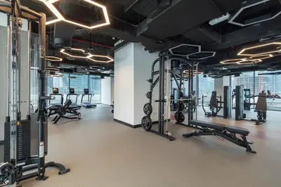 a gym with rows of treadmills and machines at Modern studio in the centre of Dubai in Dubai