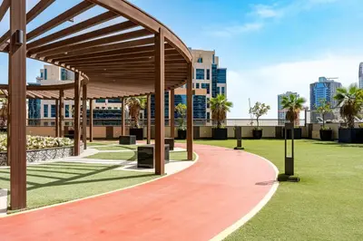a pavilion in a park with palm trees and buildings at Full burj Khalifa view chic Studio in Dubai